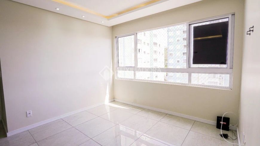 Apartamento de 02 dormitórios, living 2 ambientes, cozinha com churrasqueira, banheiro social, área